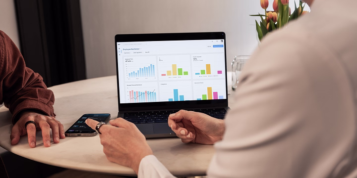 Two people discussing while looking at the Oura Enterprise Platform